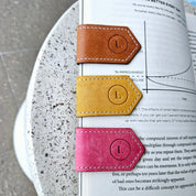 Elegant leather bookmark crafted for durability and style in brown, mustard and pink colour.