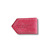 Side view of leather bookmarks in pink with an embossed logo, smooth texture, rounded edges, fine stitching, and minimalist design.