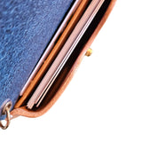 Close-up of a handmade leather pocket case with a blue interior, showing business cards neatly tucked inside a side pocket and brass hardware detailing.