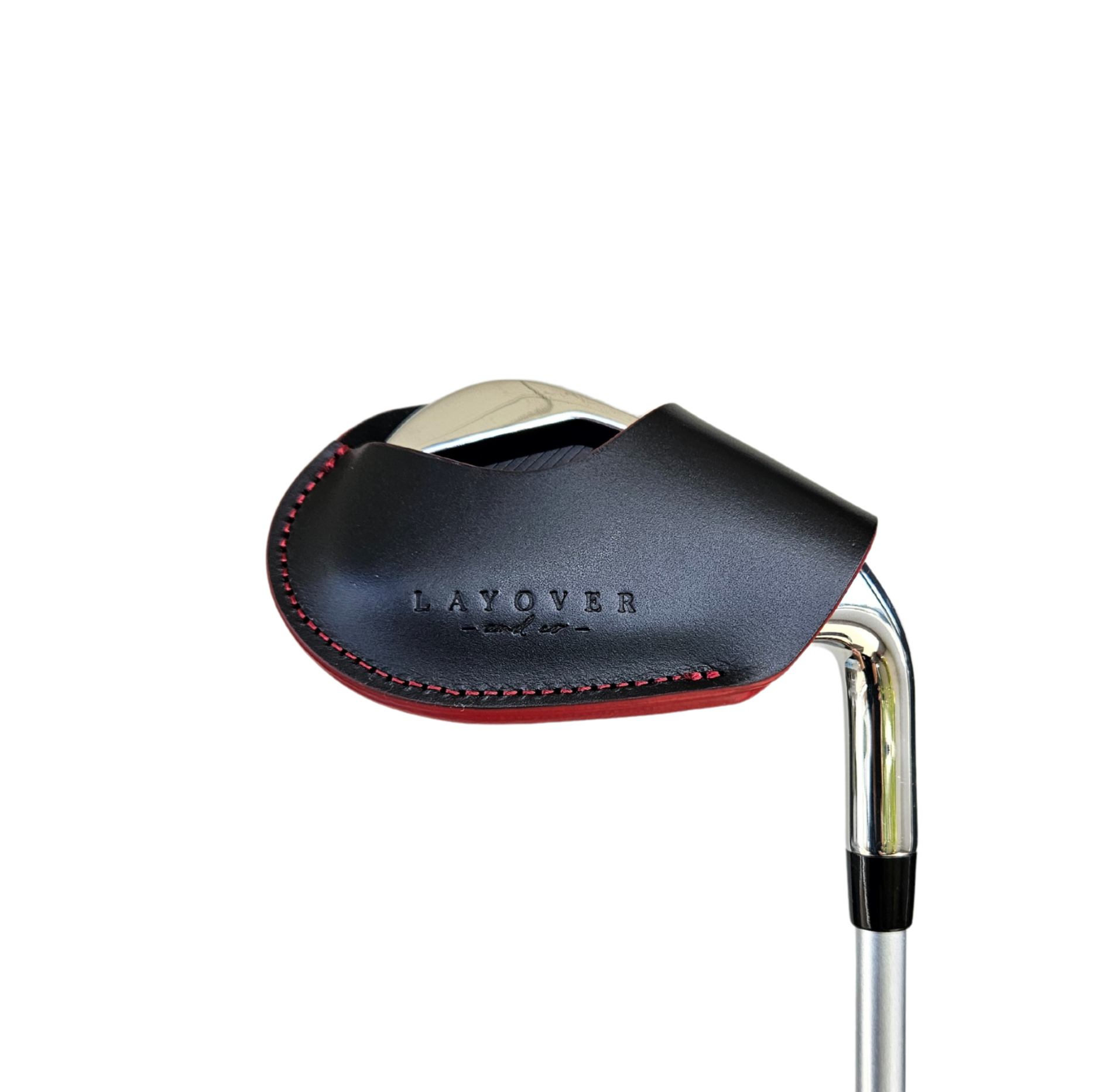 Studio shot of leather magnetic golf iron covers in black with red stitches neatly arranged to showcase their smooth texture, precise stitching, and minimalist design under soft lighting.