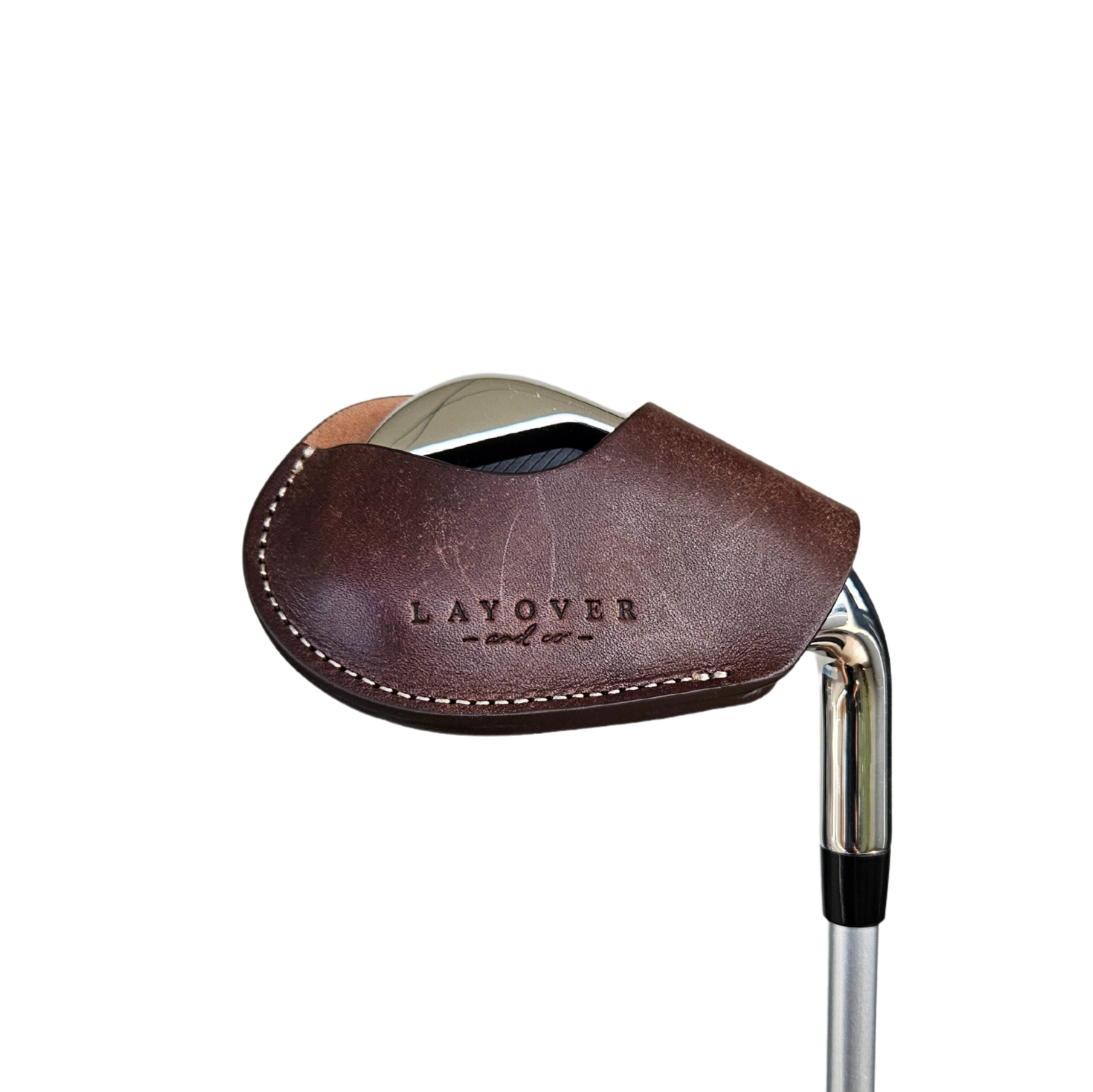 Studio shot of leather magnetic golf iron covers in brown neatly arranged to showcase their smooth texture, precise stitching, and minimalist design under soft lighting.
