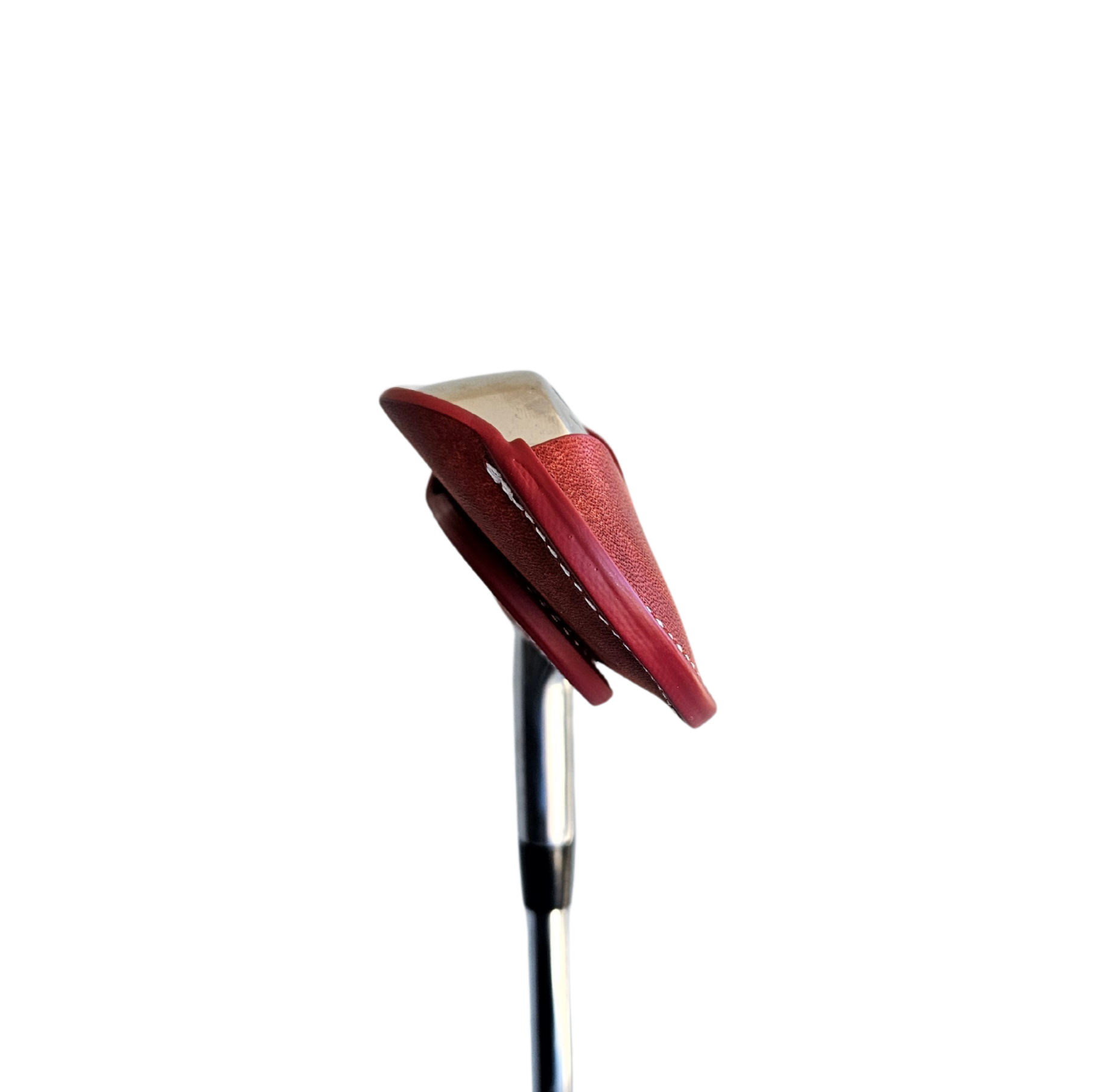 Studio shot of leather magnetic golf iron covers in red neatly arranged to showcase their smooth texture, precise stitching, and minimalist design under soft lighting.