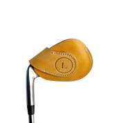 Studio shot of leather magnetic golf iron covers in yellow neatly arranged to showcase their smooth texture, precise stitching, and minimalist design under soft lighting.